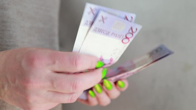 Female hands holding paper bills Belarusian rubles 