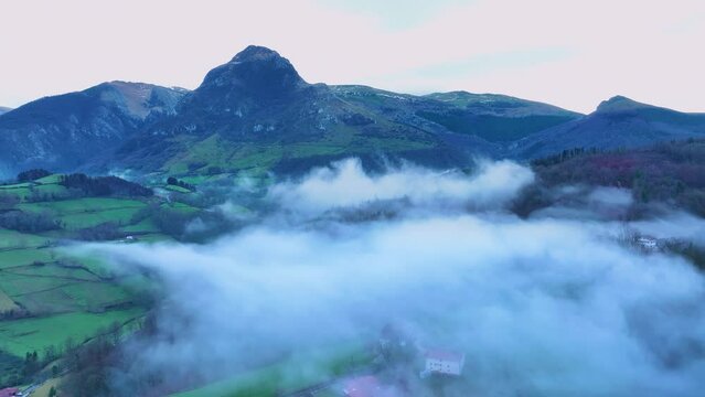 Aerial drone view of the winter landscape around the town of Gainza and Amezqueta and the Txindoki Mountain. Aralar Mountain Range. Goierri region. Gipuzkoa. Basque Country. Spain. Europe