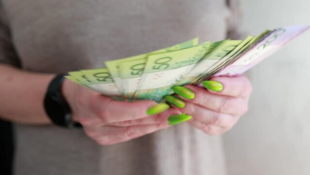 Female hands holding paper bills Belarusian rubles 