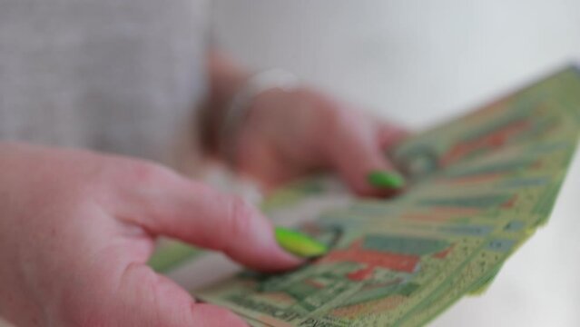 Female hands holding paper bills Belarusian rubles 