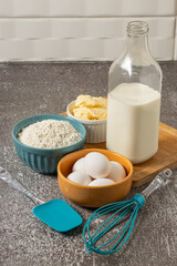 Ingredients to prepare cake. Wheat flour, eggs, butter and milk.
