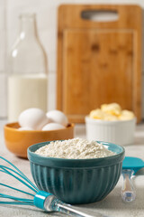 Ingredients to prepare cake. Wheat flour, eggs, butter and milk.