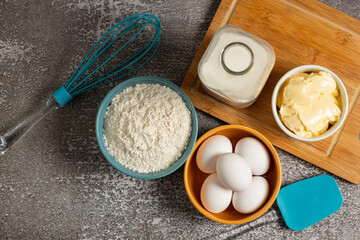 Obraz na płótnie Canvas Ingredients to prepare cake. Wheat flour, eggs, butter and milk.