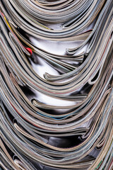 Old magazine newspapers stacks on toned blur background, top view