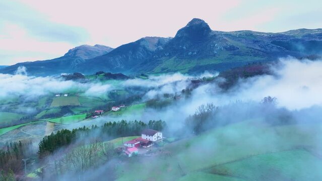 Aerial drone view of the winter landscape around the town of Gainza and Amezqueta and the Txindoki Mountain. Aralar Mountain Range. Goierri region. Gipuzkoa. Basque Country. Spain. Europe