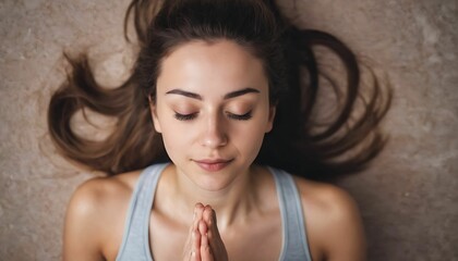 Beautiful young woman in a yoga pose and meditating with closed eyes, view from above created with generative ai
