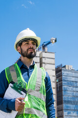 Construction worker man portrait in construction site in sunny day