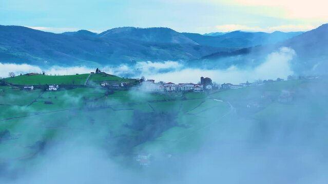 Aerial drone view of the winter landscape around the town of Gainza and Amezqueta and the Txindoki Mountain. Aralar Mountain Range. Goierri region. Gipuzkoa. Basque Country. Spain. Europe