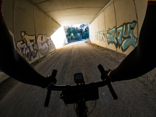 Riding a bicycle inside a dark tunnel