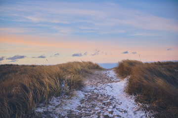 Snowy Pathway to the beach during evening in winter. High quality photo