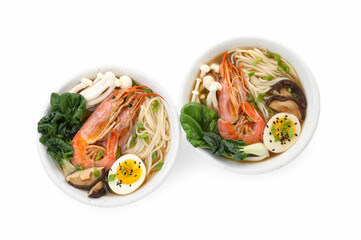 Delicious ramen with shrimps and eggs in bowls isolated on white, top view. Noodle soup