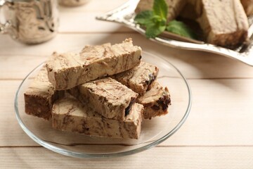 Tasty chocolate halva on wooden table, closeup