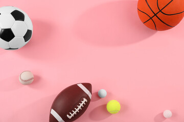 Many different sports balls on pink background, flat lay. Space for text