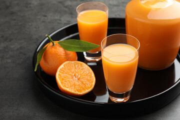 Delicious tangerine liqueur and fresh fruits on grey table