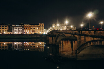 Fototapeta na wymiar Embankment of Arno River at night, in Florence, Italy