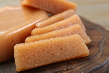 Tasty sweet quince paste on wooden board, closeup