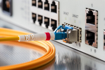 Fiber optic patch cord cable connected to switch in office internet network