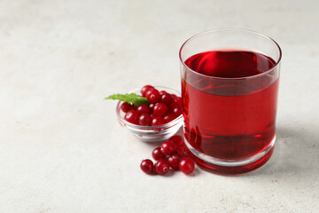 Tasty refreshing cranberry juice, mint and fresh berries on light table. Space for text