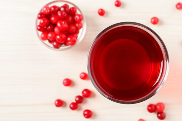 Tasty cranberry juice in glass and fresh berries on white wooden table, flat lay. Space for text