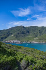 Fototapeta na wymiar Corsica, seascape in the cap Corse, a creek with a boat 