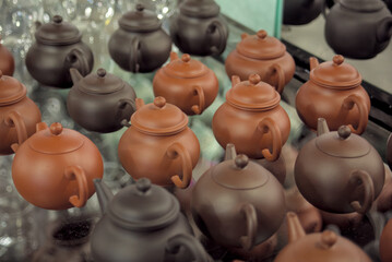 Fototapeta na wymiar handmade teapots pots in the market glass ceramic orange red artisan shopping commerce pottery