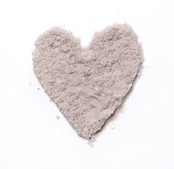 Sandy Heart. Love Symbol made of Fine Sand. White Background. No text. Sunny Beach Sand Arranged in the Shape of a Heart. Summer Love.