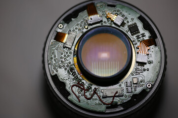 Detailed view of a camera lens interior showing intricate electronic circuitry and lens elements