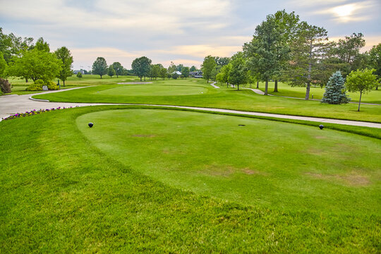 Serene Golf Course at Sunset with Manicured Greens and Tee Box Perspective