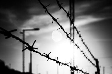 Close up of barbed wire against the sky