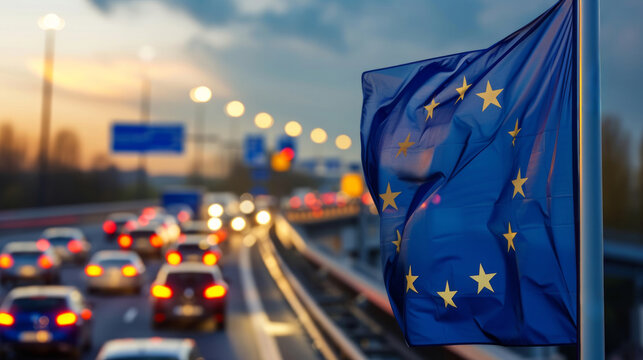 Vielbefahrene Stra&szlig;e mit Flagge der Europ&auml;ischen Union (EU)  im Vordergrund.
