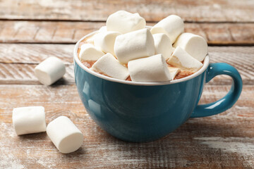 Tasty hot chocolate with marshmallows on wooden table, closeup
