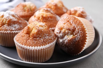 Delicious sweet muffins on grey table, closeup