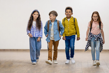 Group of school kids walking in corridor.