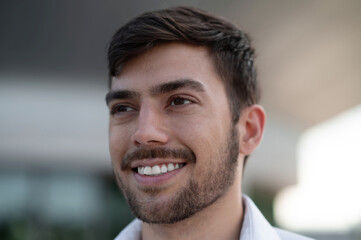 Fototapeta premium Bearded young man looking contented and smiling