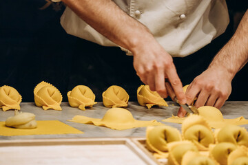 The chef prepares the cappellacci with ricotta and spinach