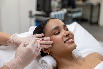 Young dark-skinned woman having a session of mesotherapy