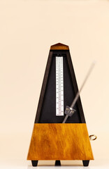 Wooden Mechanical Metronome On Light Background