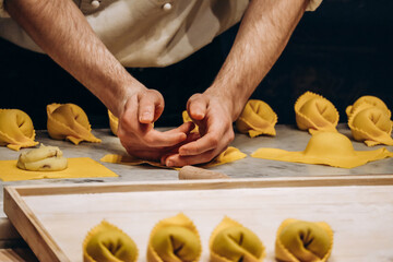 The chef prepares the cappellacci with ricotta and spinach