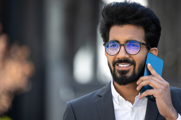Good-looking hindu businessman having a phone call