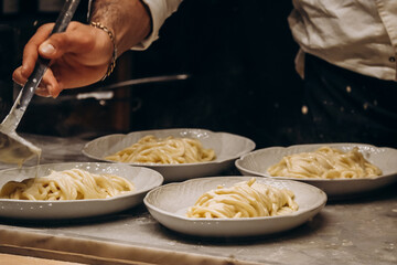 Italian chef preparing spaghetti with sauce