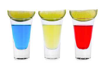 Different shooters in shot glasses and lime wedges isolated on white. Alcohol drink