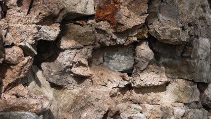 in the photo there is a close-up of an old stone wall