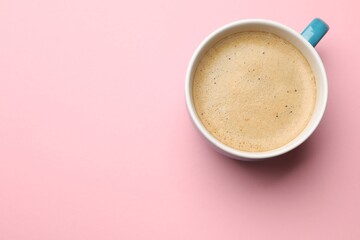 Fresh coffee in cup on pink background, top view. Space for text