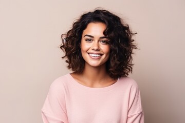 Portrait of a beautiful young woman smiling and looking at camera.