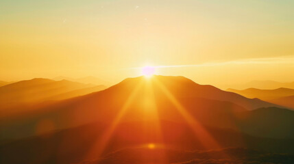 A mountain range in the distance with the sun setting behind it creating a dreamy and ethereal backlight effect.