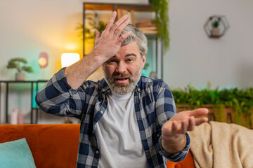 Webcam view. Dissatisfied middle-aged gray haired bearded man arguing quarrel talking on video call...