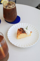 Basques Cheesecake with cream on white plate. A piece of cake on table in cafe. dessert. Fresh baked by homemade recipe.