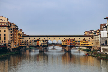Fototapeta premium The Ponte Vecchio, a medieval stone closed-spandrel segmental arch bridge over the Arno, in Florence, Italy