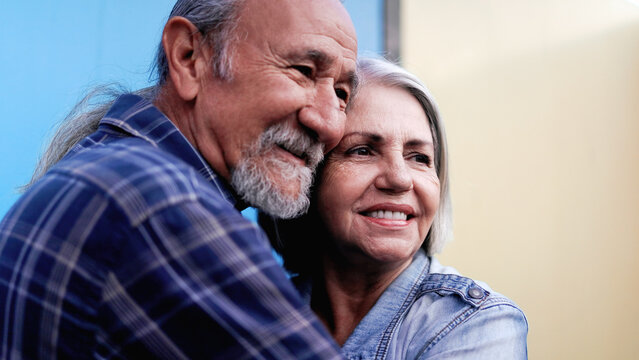 Happy senior couple hugging each other. Elderly love and multiracial joyful life style