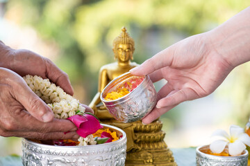  We express our respect to our elders by pouring flowers scented water onto our parents' and...